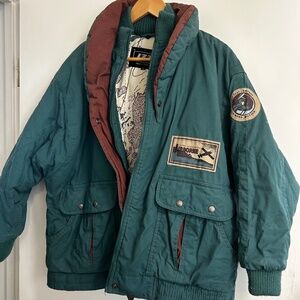 Green bomber jacket with travel designs